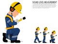 A worker with earmuff is operating sound level measuring equipment Royalty Free Stock Photo