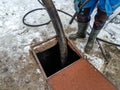 Worker emptying the septic tank with a sewage cleaner machinery Royalty Free Stock Photo