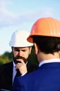 Worker and engineer hold meeting. Architect with puzzled face Royalty Free Stock Photo