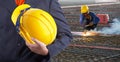 Worker or engineer holding in hands yellow helmet