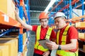 worker and engineer with tablet computer at warehouse Royalty Free Stock Photo