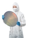 Worker or engineer wears medical protective suit or white coverall suit with silicon wafer Royalty Free Stock Photo