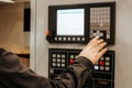 A worker entering data into a CNC machine at the factory. Metallurgical industry Royalty Free Stock Photo