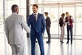 Worker at entrance shake hands with partner Royalty Free Stock Photo