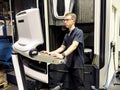 A worker examines the on-board computer of a new CNC milling machine
