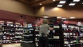 Worker exhibiting wine on the display rack