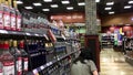 Worker exhibiting wine on the display rack