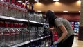 Worker exhibiting wine on the display rack