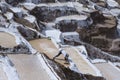 Worker extracting manually salt from the Maras salt ponds