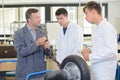 Worker and factory apprentices in factory in workshop Royalty Free Stock Photo