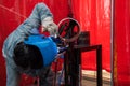 Worker in factory cutting steel pipe Royalty Free Stock Photo