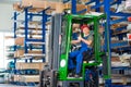 Worker in factory in lift truck with thumb up