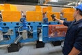 Worker at factory. man works with a measuring device