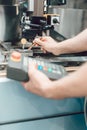 Worker in factory putting tool into a punching machine