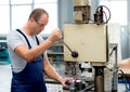 Worker in factory using drill machine Royalty Free Stock Photo