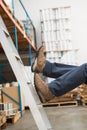 Worker falling off ladder in warehouse Royalty Free Stock Photo