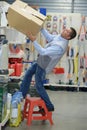Worker falling off ladder in warehouse Royalty Free Stock Photo