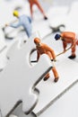 Worker figurine on puzzle pieces Royalty Free Stock Photo