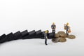 Worker figurines around an euro Royalty Free Stock Photo