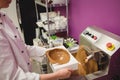 Worker filling mould with melted chocolate