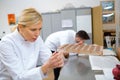 worker filling mould with melted chocolate in kitchen