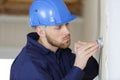 Worker filling wall with putty