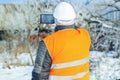 Worker filmed with tablet PC near abandoned house in winter Royalty Free Stock Photo