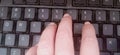 Worker finger typing on keyboard