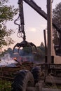 A worker at fiskars disassembles a pile of boards at the site of the fire to free up the entrance to the scene