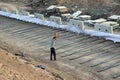 A worker fitting Concrete barriers or safety barriers by the leather belt on the new under-construction highway site in India Royalty Free Stock Photo