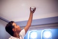 A man worker fix fire system on the ceiling. Building, renovation and electricity concept Royalty Free Stock Photo