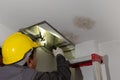 Worker fix leaking pipe in ceiling ,close-up of a stain on the ceiling Royalty Free Stock Photo