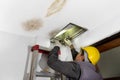 Worker fix leaking pipe in ceiling ,close-up of a stain on the ceiling Royalty Free Stock Photo