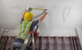 Worker fix leaking pipe in ceiling ,close-up of a stain on the ceiling Royalty Free Stock Photo