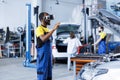 Worker fixes car exhaust system with VR Royalty Free Stock Photo