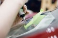 Worker fixes crack in car glass windshield, repair drills and pours epoxy Royalty Free Stock Photo