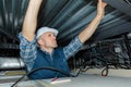 Worker fixing ceiling panel in building Royalty Free Stock Photo