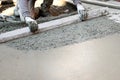 Worker flattening concrete floor Royalty Free Stock Photo