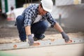 worker flattening freshly laid concrete outdoors with length metal Royalty Free Stock Photo