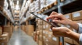 Worker focuses on tablet while scanning barcodes in warehouse, managing documents and tracking cargo efficiently Royalty Free Stock Photo