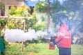 Worker fogging residential area