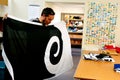 Worker fold the Koru flag