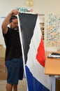 Worker fold the Red Peak flag