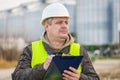 Worker with folder near the factory in winter Royalty Free Stock Photo