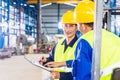 Worker and forklift driver in industrial factory Royalty Free Stock Photo