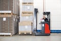 Worker In Forklift Examining Stockpile