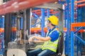 Worker on forklift, Manual workers working in warehouse, Worker driver at warehouse forklift loader works Royalty Free Stock Photo