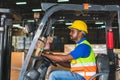 Worker on forklift, Manual workers working in warehouse, Worker driver at warehouse forklift loader works Royalty Free Stock Photo