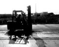 Worker on forklift wait for lift out cargo on struck by black and white photography Royalty Free Stock Photo