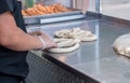 Worker forms a pretzel from bread dough